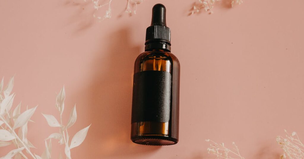 Elegant flatlay of a dropper bottle beauty product on a pastel background for skincare.